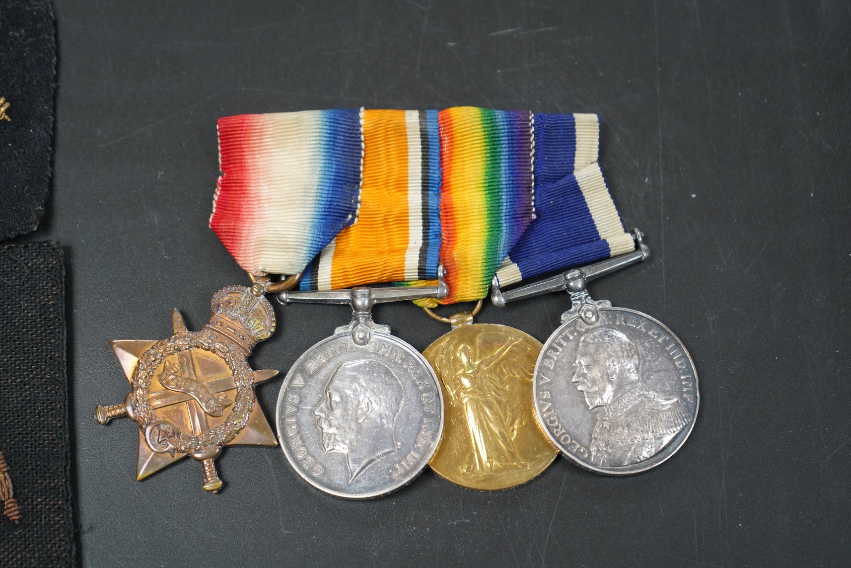 A WWI medal group including Good Conduct awarded to 226989 JHW.PUCKETT.PO.RN. (HMS PEMBROKE) together with cloth badges and a tag